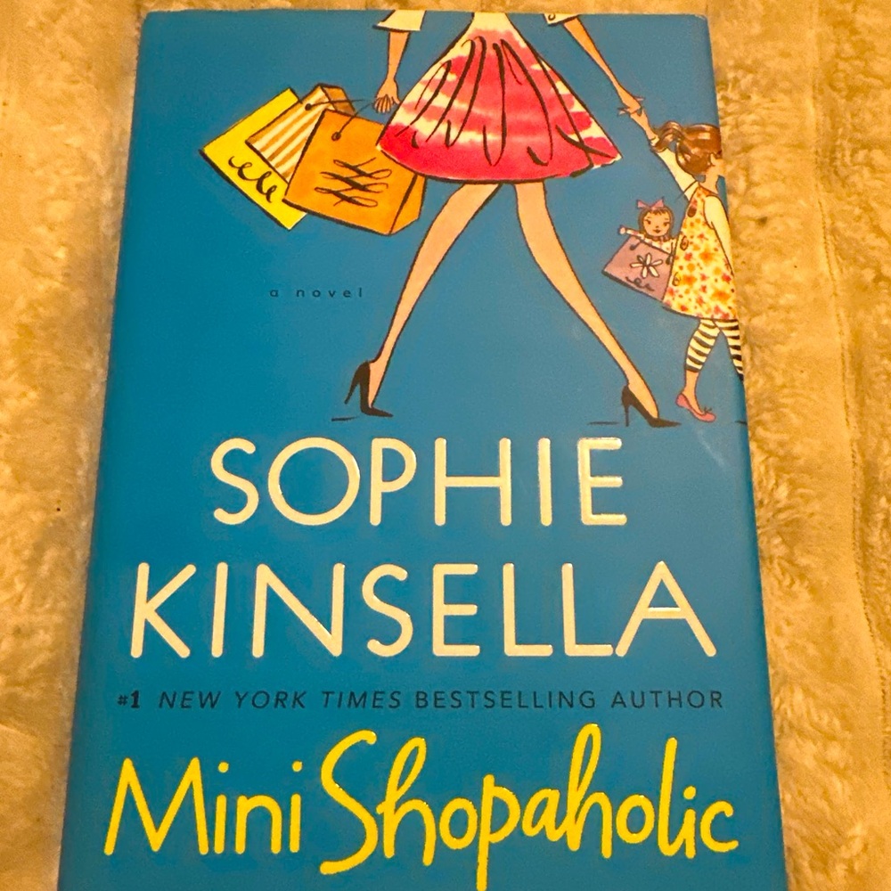 This is a wonderful hardcover book titled "Mini Shopaholic" by Sophie Kinsella.